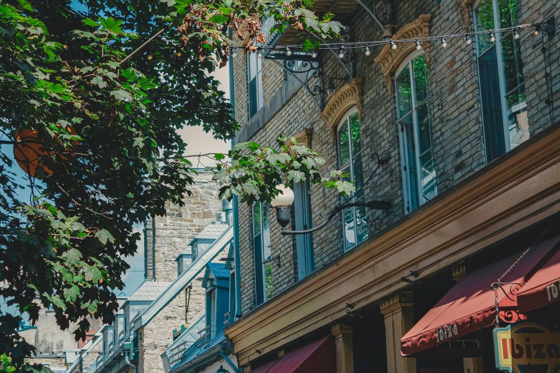 Stone facades and restaurant awnings on a street in Old Quebec